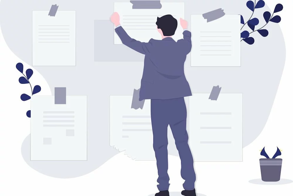 person hanging papers on a wall