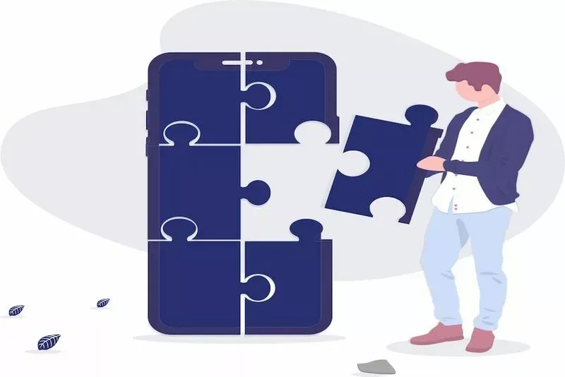 man fitting puzzle pieces together on mobile device